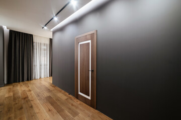 Interior design of the house with black walls and wood flooring