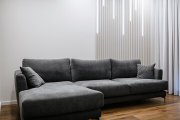 big black sofa in a new light interior