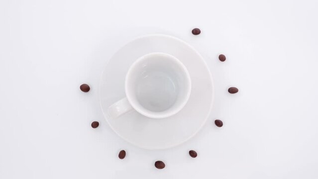 A coffee cup on a white saucer is filled with hot espresso, caffeine, vigor in the morning