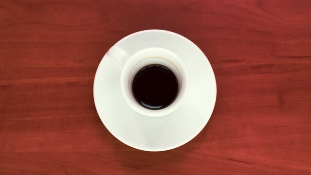 Stop motion animation of a full cup of espresso coffee being gradually emptied. Energy, vivacity.