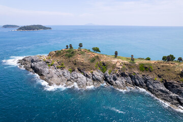 Aerial view phuket seashore Wave crashing on rocks at Laem promthep cape beautiful sea in Phuket Thailand.Phuket view point is famous tourist destination at Thailand