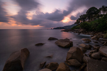 Waves over the rocks at the seashore in Long exposure photography