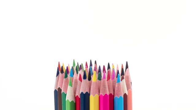 A bunch of multi-colored wooden pencils on a white background with the word open changing to closed. Stop motion animation.