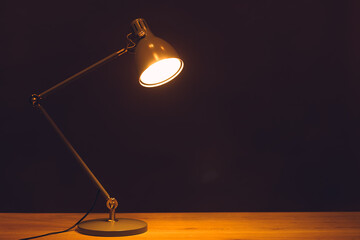 desk lamp, black background with copy-space