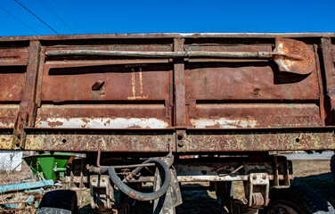 Fototapeta na wymiar Old rusty car trailer of cargo transport