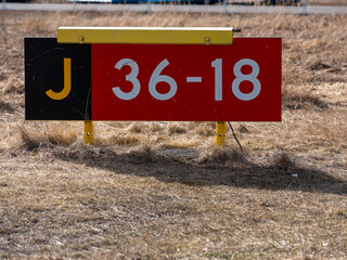 Closeup of runway hold position sign at taxiway J