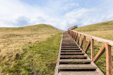 Fototapeta na wymiar Hiking up wooden stairs to the Seredzius mound, Lithuania