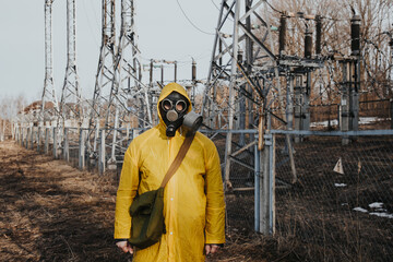 male worker standing on territory of power station. Environmentalist wearing protective uniform,...