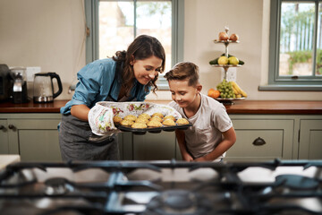Nothing beats the smell of homemade muffins. Shot of a woman and her son baking together in the...