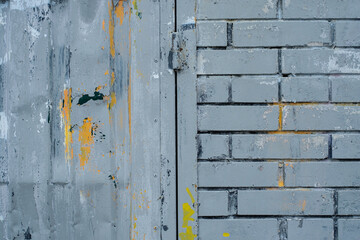 The texture of the brick wall is covered with old paint