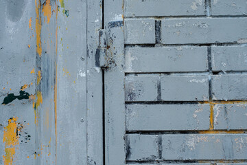 The texture of the brick wall is covered with old paint