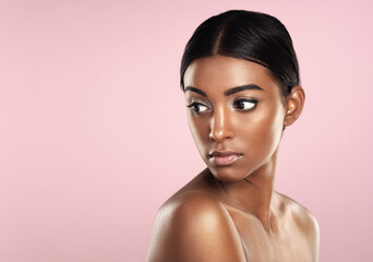Fototapeta premium Beauty that is naturally perfect. Studio shot of a beautiful young woman posing against a pink background.