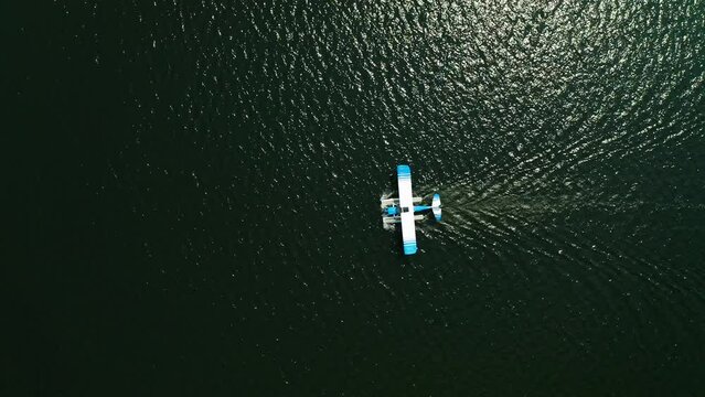 Aerial top down, seaplane floating on ocean lake water
