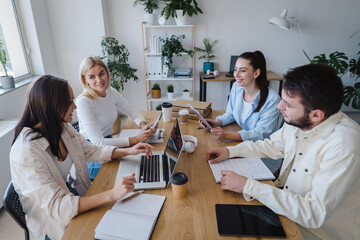 Group of young modern people in smart casual wear discussing business