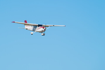 Small Single Engine Prop airplane coming in for a landing blue sky
