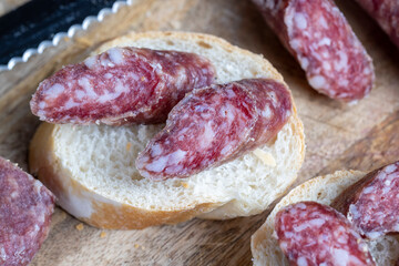 sliced pieces of sausage from meat are lying on a cutting board