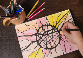 black marker pen on a multicolored drawing from neurographic lines. neurographics as a...