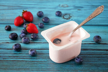 morning breakfast with fresh fruits and yogurt or milk on a white wooden background,