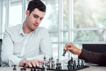 Businessman moving chess piece on chess board game concept for ideas and competition and strategy,...