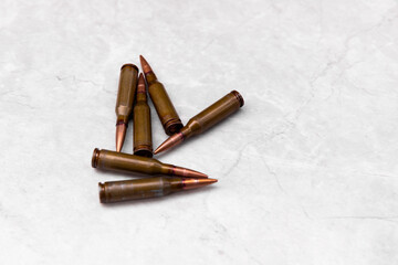 Bullets on a gray background. Cartridges of caliber 7.62 for the Kalashnikov assault rifle. View...