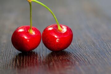 red sweet cherry on a wooden table