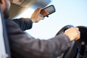Capturing memories one mile at a time. Shot of a young man taking a selfie in his car.