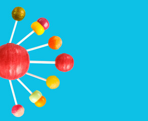 Multi-colored candies on a stick, blue background.Many colorful lollipops (Chyupa-Chyups) on a blue background