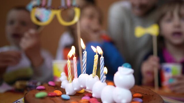 Birthday cake anniversary celebration with children in the background