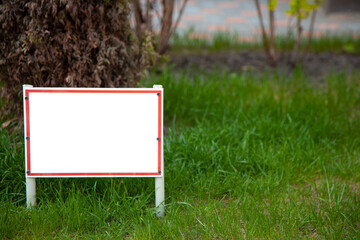 Pointer sign on the lawn with green grass. Banner layout with place for the text dog walking is prohibited , do not walk on the lawn, it is dangerous. Information board layout. Mockup.