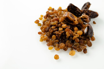 dry fruits of dates and raisins, on a white background, close-up