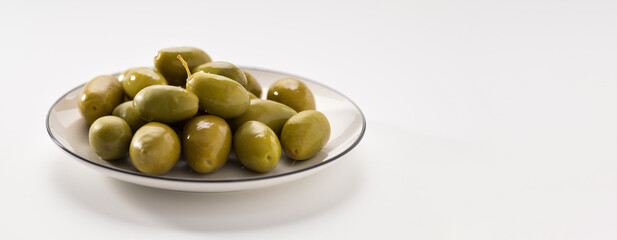 Green pickled olives on a white background, banner, space for text