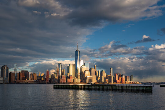 Approaching storm with the skyscrapers of Lower Manhattan at sunset. New York City cityscape and the World Trade Center from across the Hudson River