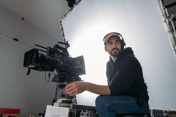 Director of photography with a camera in his hands on the set. Professional videographer at work on filming a movie