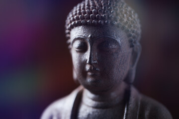 Meditating Buddha Statue on dark wooden background. Close up. Copy space.	