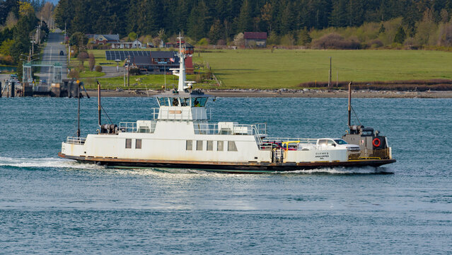 Anacortes, WA, USA - April 12, 2022; Small car ferry Guemes crossing from the island to the mainland at Anacortes in evening light