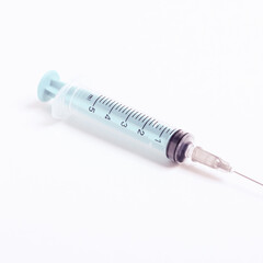 Medical syringe on a white background. A syringe for injection. The concept of health and beauty