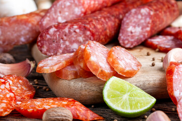 sliced pieces of sausage from meat are lying on a cutting board