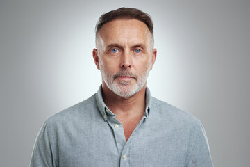 You simply have to believe in yourself. Studio portrait of a mature man standing against a grey background.