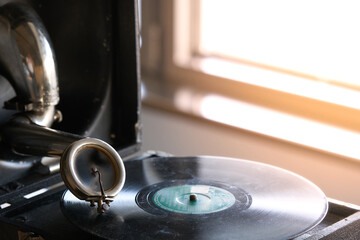 antique portable gramophone with a powder covered vinyl record