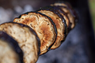 barbecue with cooking fresh eggplant on the fire