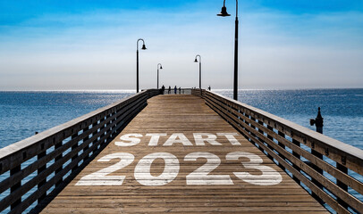 Start 2023 written on the wooden planks of a pier on the Pacific Coast	
