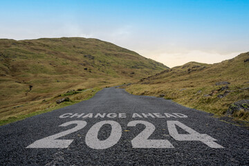 Change Ahead 2024 written on a mountain pass road in the Lake District.