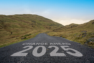 Change Ahead 2025 written on a mountain pass road in the Lake District.