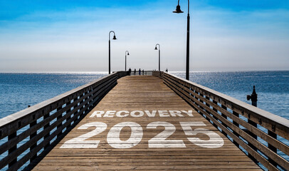 Recovery 2025 written on the wooden planks of a pier on the Pacific Coast	
