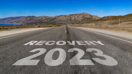 Recovery 2023 written on highway road to the mountain	
