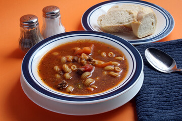 A bowl of cowboy soup with French bread.