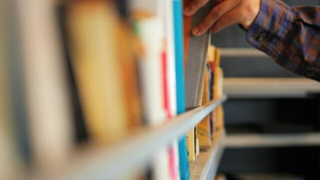 Student woman taking book from shelf in library. 4K Slowmotion Educational Concept Footage.
