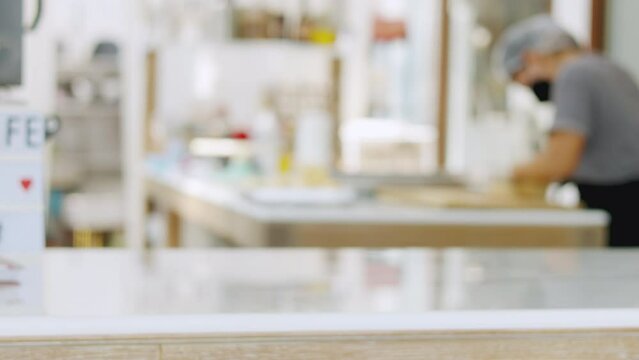 Selective focus and blurred background of beautiful bright and white decorative kitchen with people or chef is working to prepare delicious meal, food and bakery for lunch or dinner.