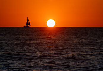 Obraz na płótnie Canvas Sailboat Silhouette Sailing Ocean Sunset
