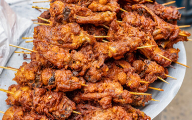 Delicious fried chicken with stick on a street market